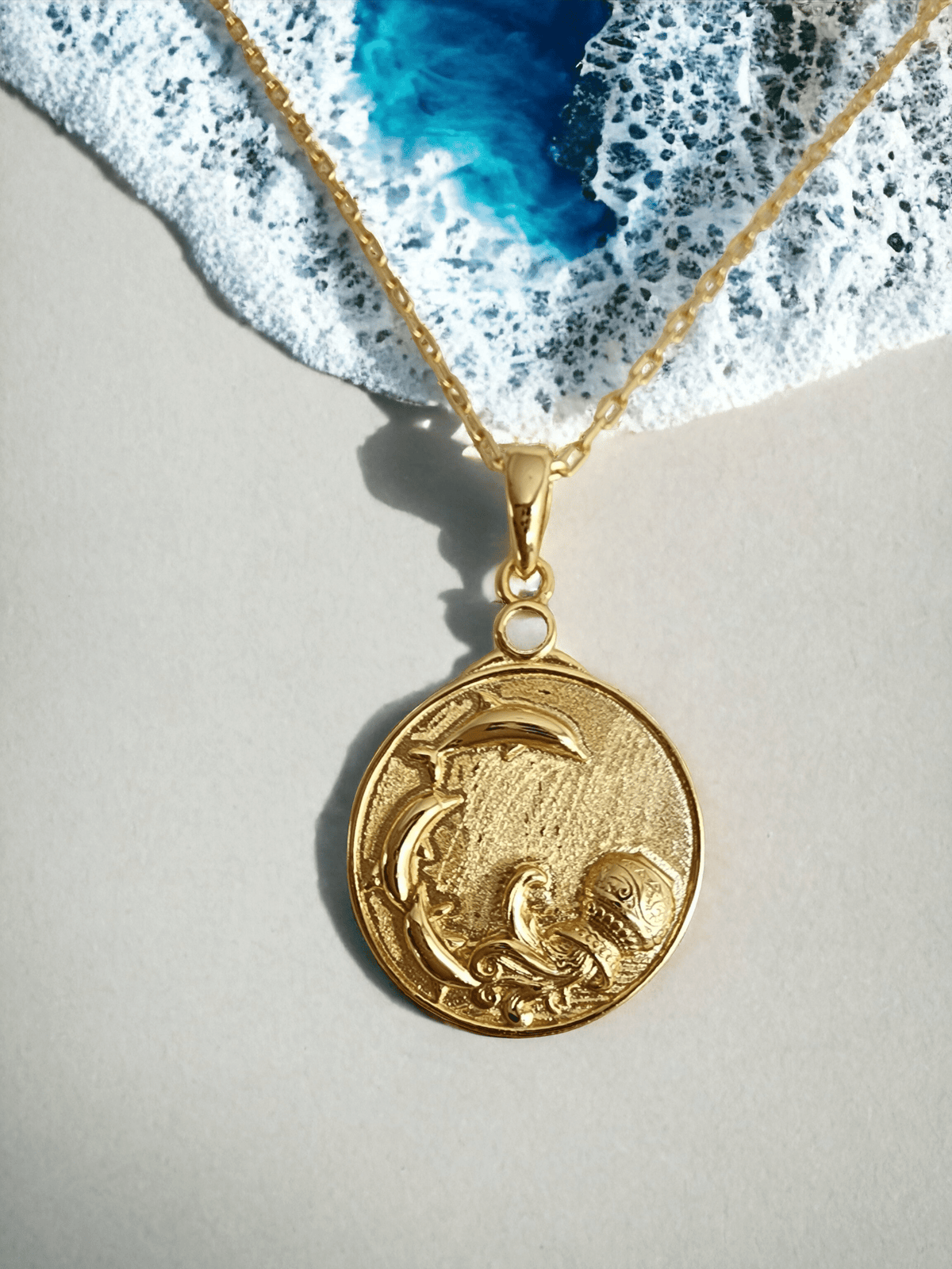 Gold Zodiac Aquarius Medallion Necklace with dolphins leaping from a water urn