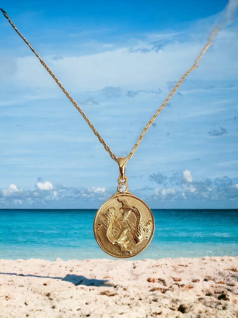 Gold Zodiac Pisces Necklace with beach background