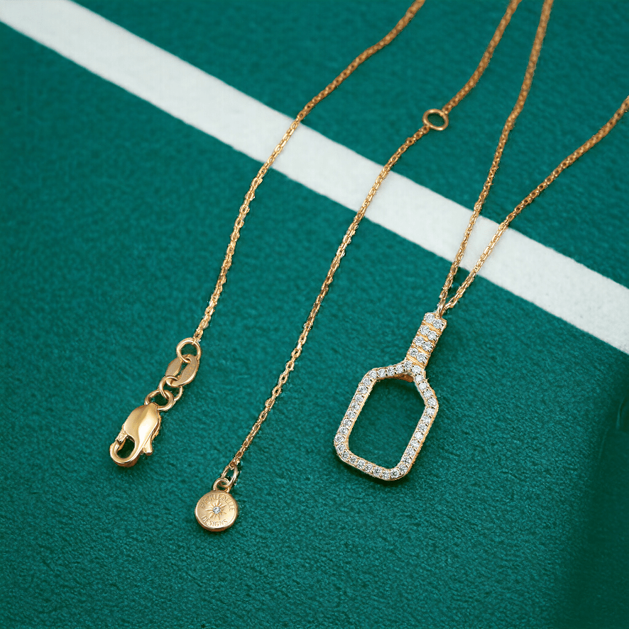 Pickleball Belle Volley FINE Necklace Solid 14k Gold Racquet with Diamonds on green backdrop