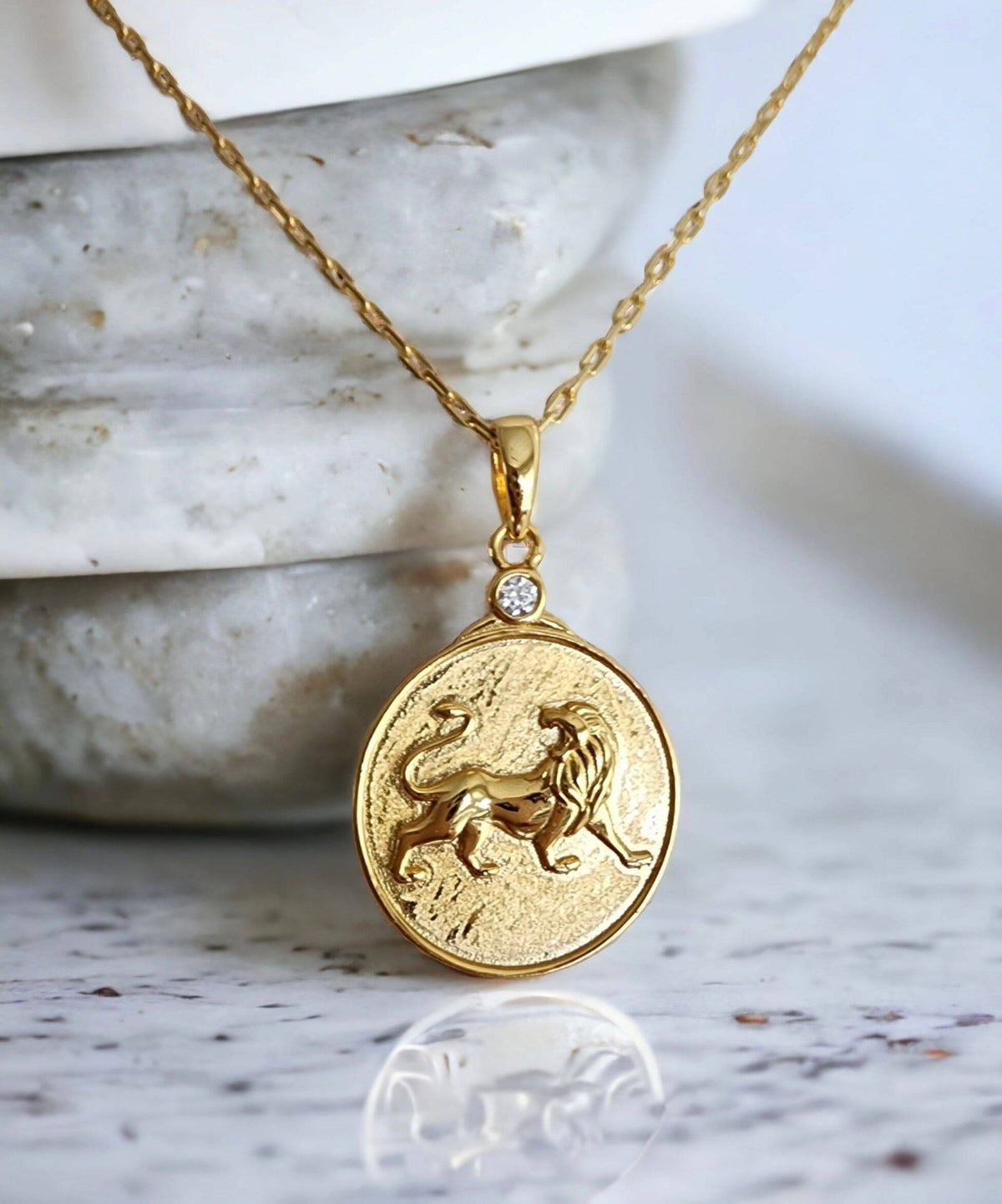 Gold Zodiac Leo Lion Medallion Necklace on Granite Background