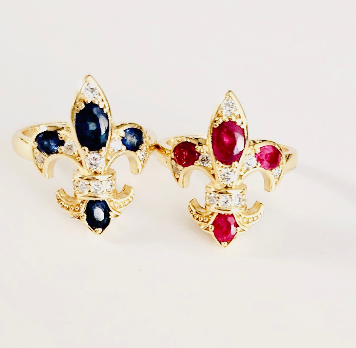 Saints & Saviors Gold Fleur De Lis RUBY or SAPPHIRE Rings with Diamonds, side by side