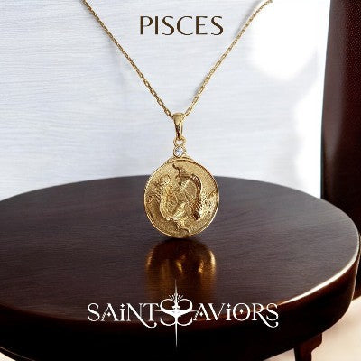 Gold necklace with a Pisces Zodiac pendant on a wooden surface
