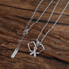 Silver necklace with pickleball paddle pendant on a wooden surface