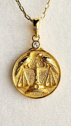 Gold Zodiac Libra V2 Necklace Depicting Two Ravens on a Scale