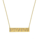 Gold necklace with a bar pendant featuring small Braille message diamonds on a white background spells out limitless