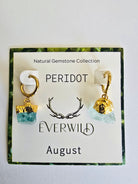 Peridot August birthstone earrings on a card with 'Everwild' branding and gemstone information.