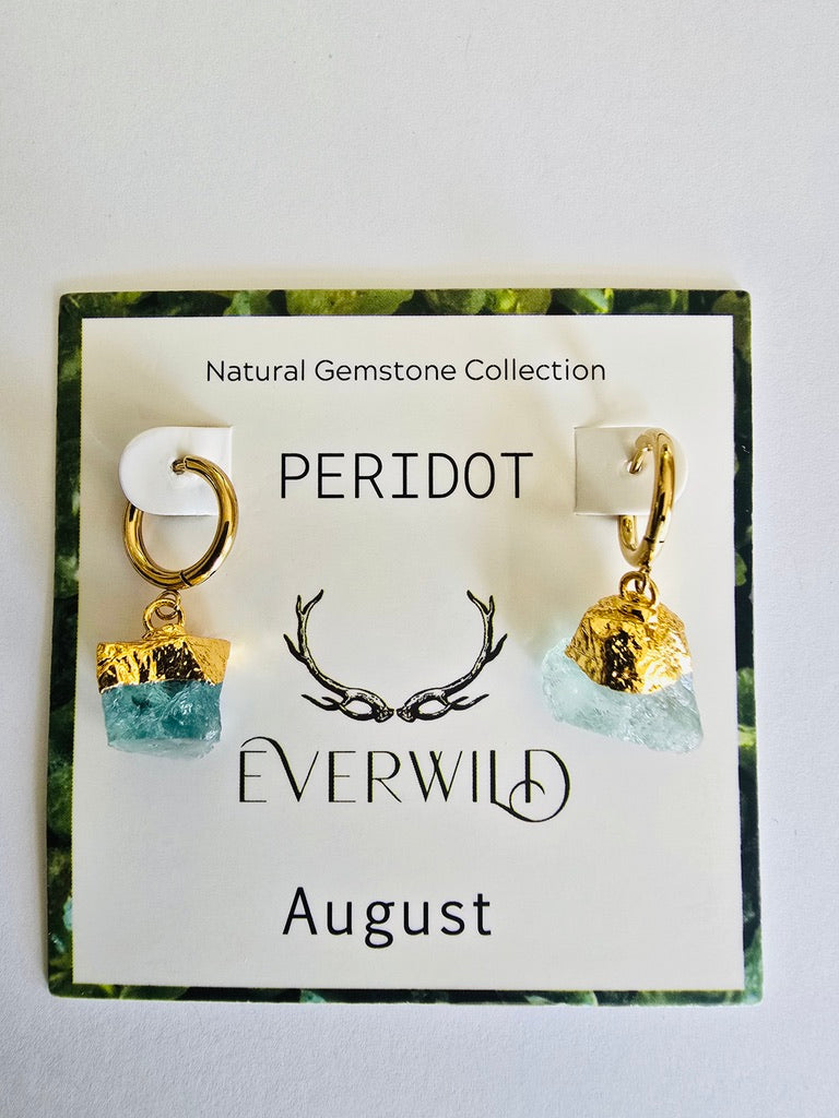 Peridot August birthstone earrings on a card with 'Everwild' branding and gemstone information.
