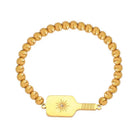 Picklebelle Gold beaded bracelet with a pickleball paddle-shaped charm on a white background