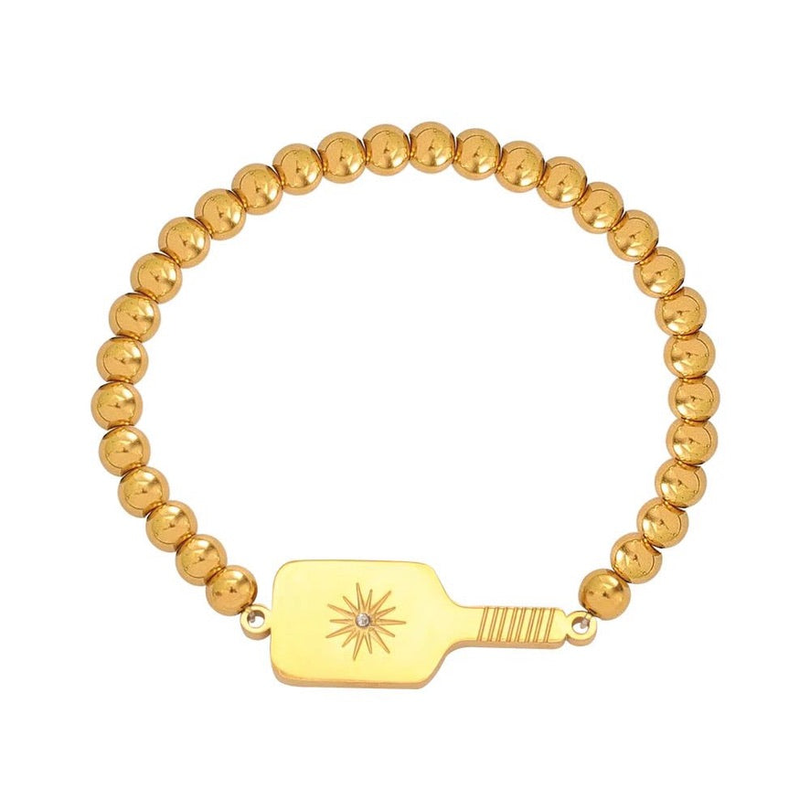Picklebelle Gold beaded bracelet with a pickleball paddle-shaped charm on a white background