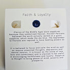Sapphire earring on a card with 'Faith & Loyalty' text and sapphire information.