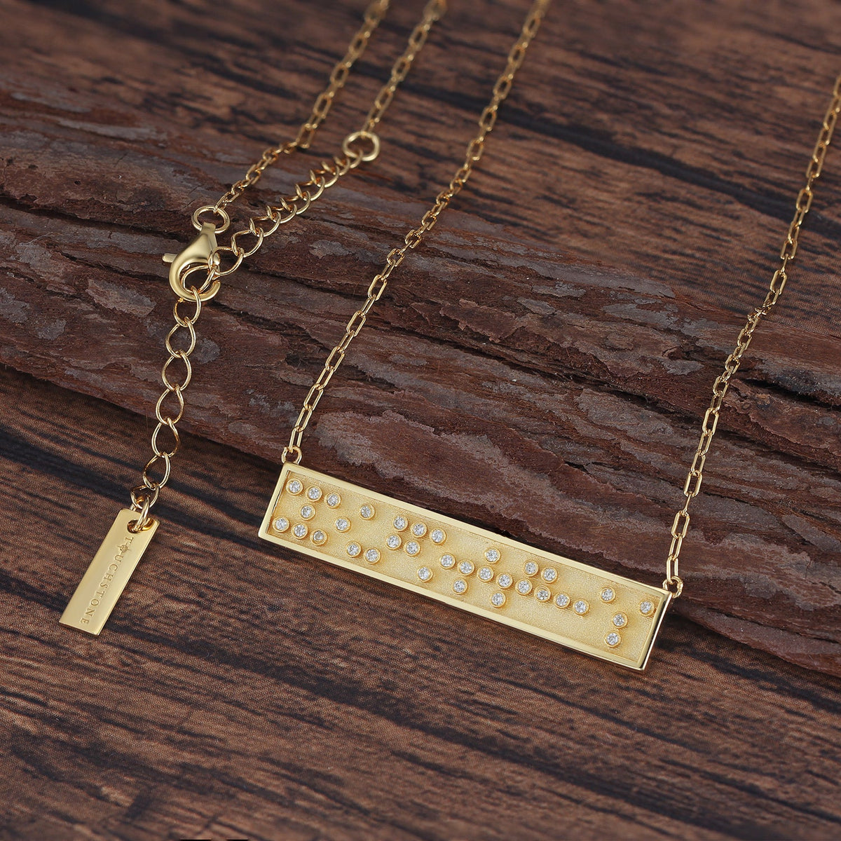 Touchstone You Got This Mini-Bar Necklace Gold with Braille 'You Got This' in Crystals on wood surface