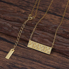 Touchstone I Love You Mini-Bar Necklace in Gold with Braille 'I Love You' in Crystals on wood surface