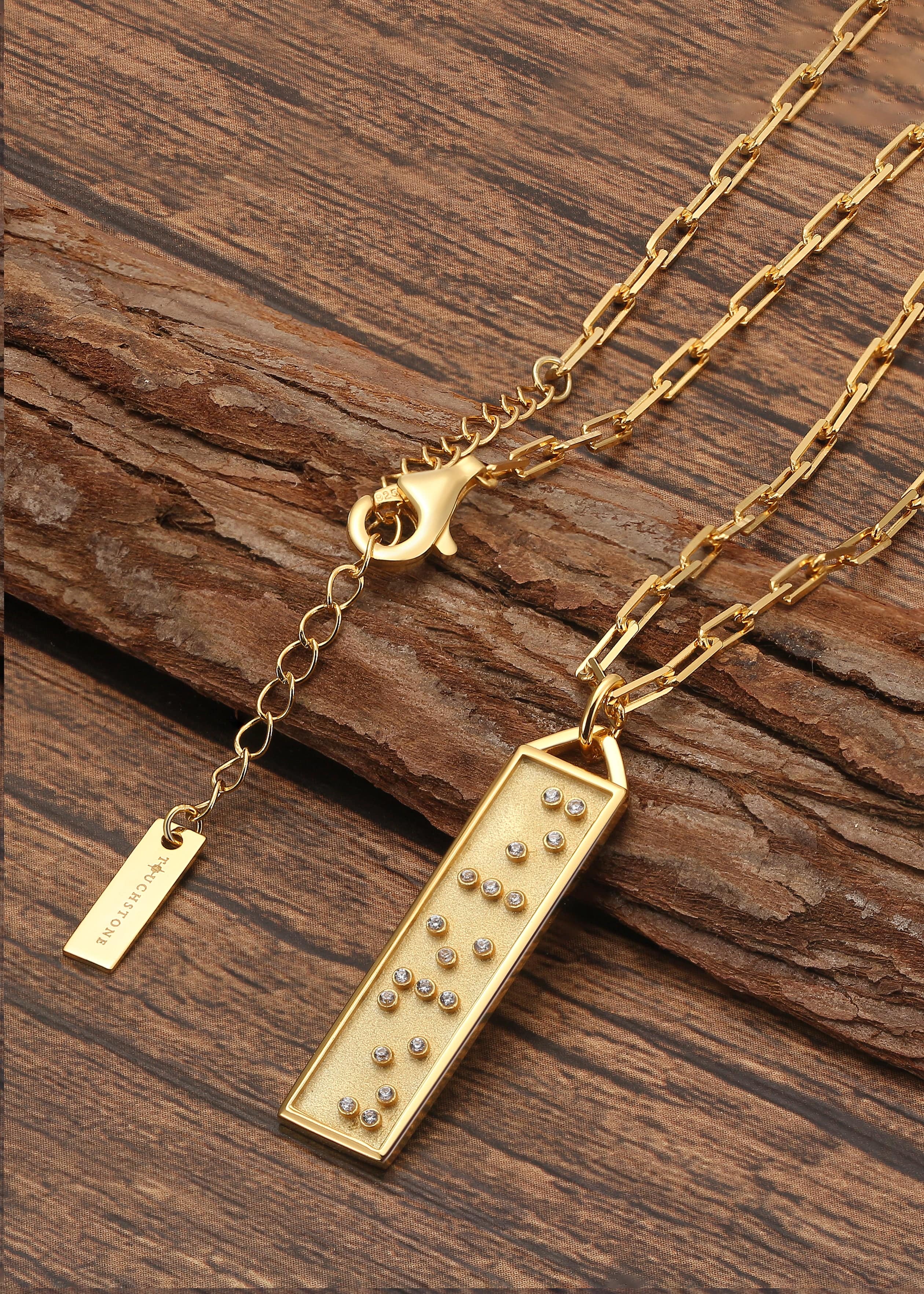 Touchstone Beloved Bar Necklace Gold on wooden surface
