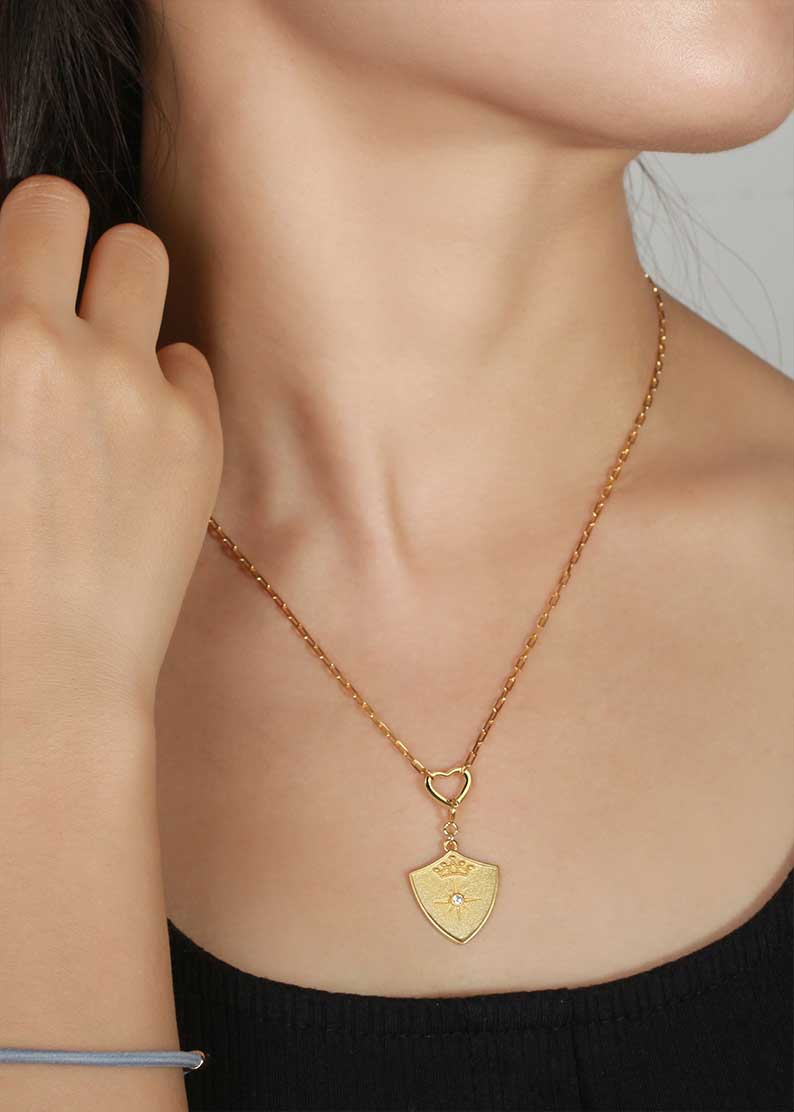 Saints and Saviors Gold Shield Crown Pendant Heart Necklace on model