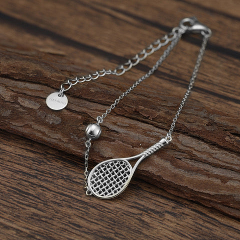 LoveMatch Tennis Ace Racquet and Ball on silver chain on wood surface