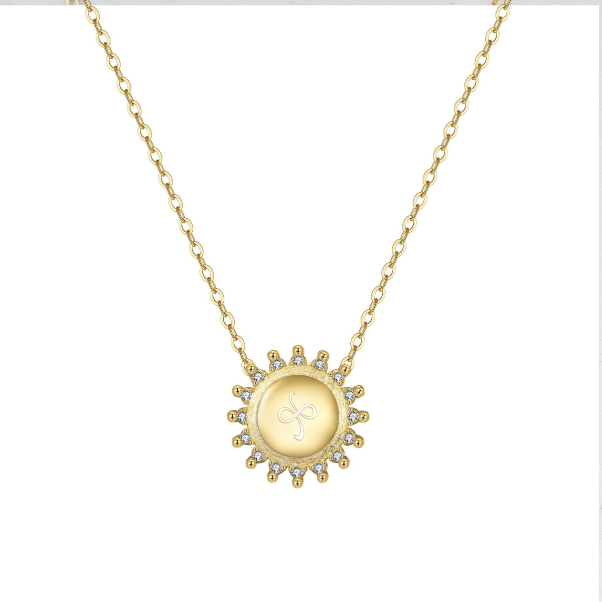 The Friendship Necklace Gold Sunburst with etched friendship symbol on white background