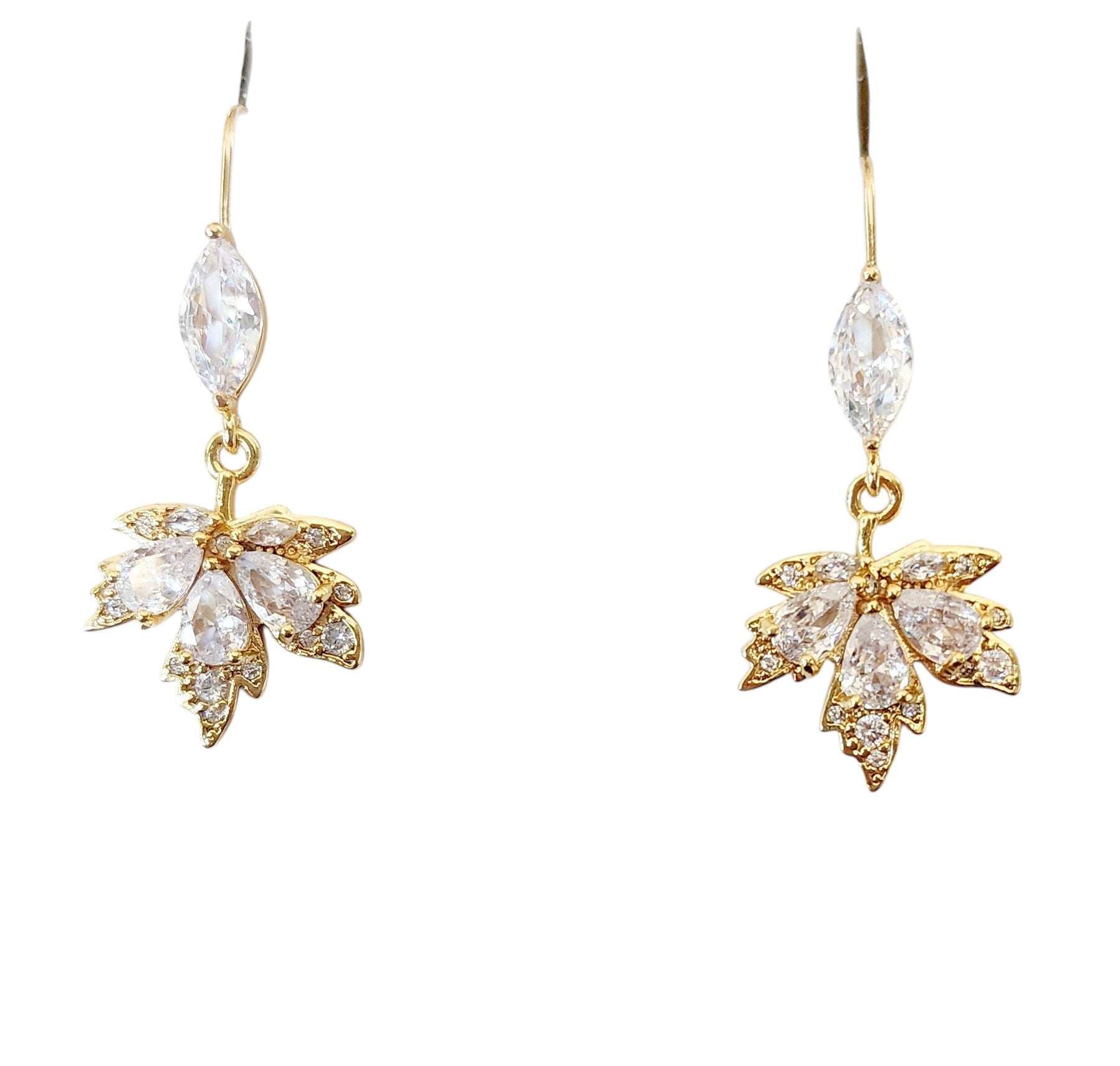 Gold maple leaf-shaped earrings with clear gemstones on a white background