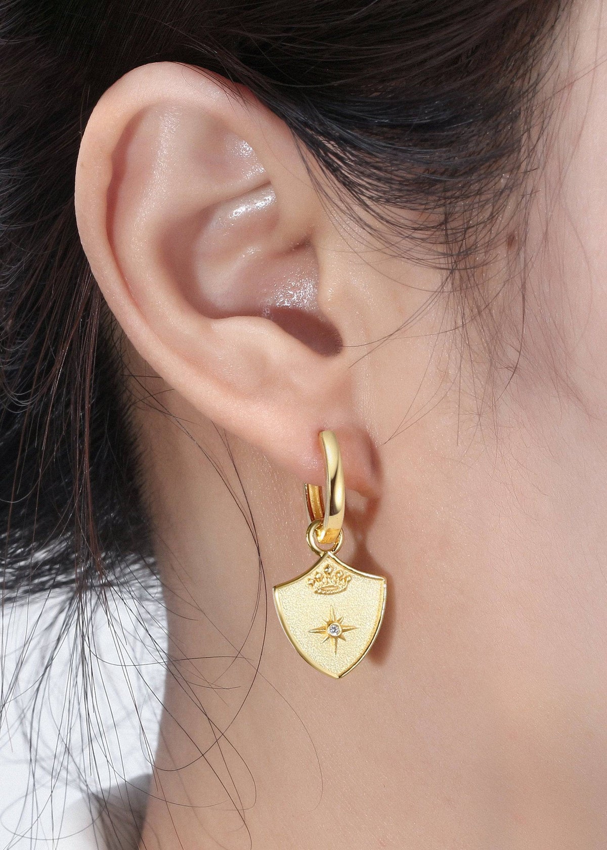 Saints & Saviors Crown Shield Huggie Earrings on model in gold